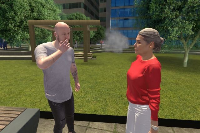 A person smokes in front of another person in a park