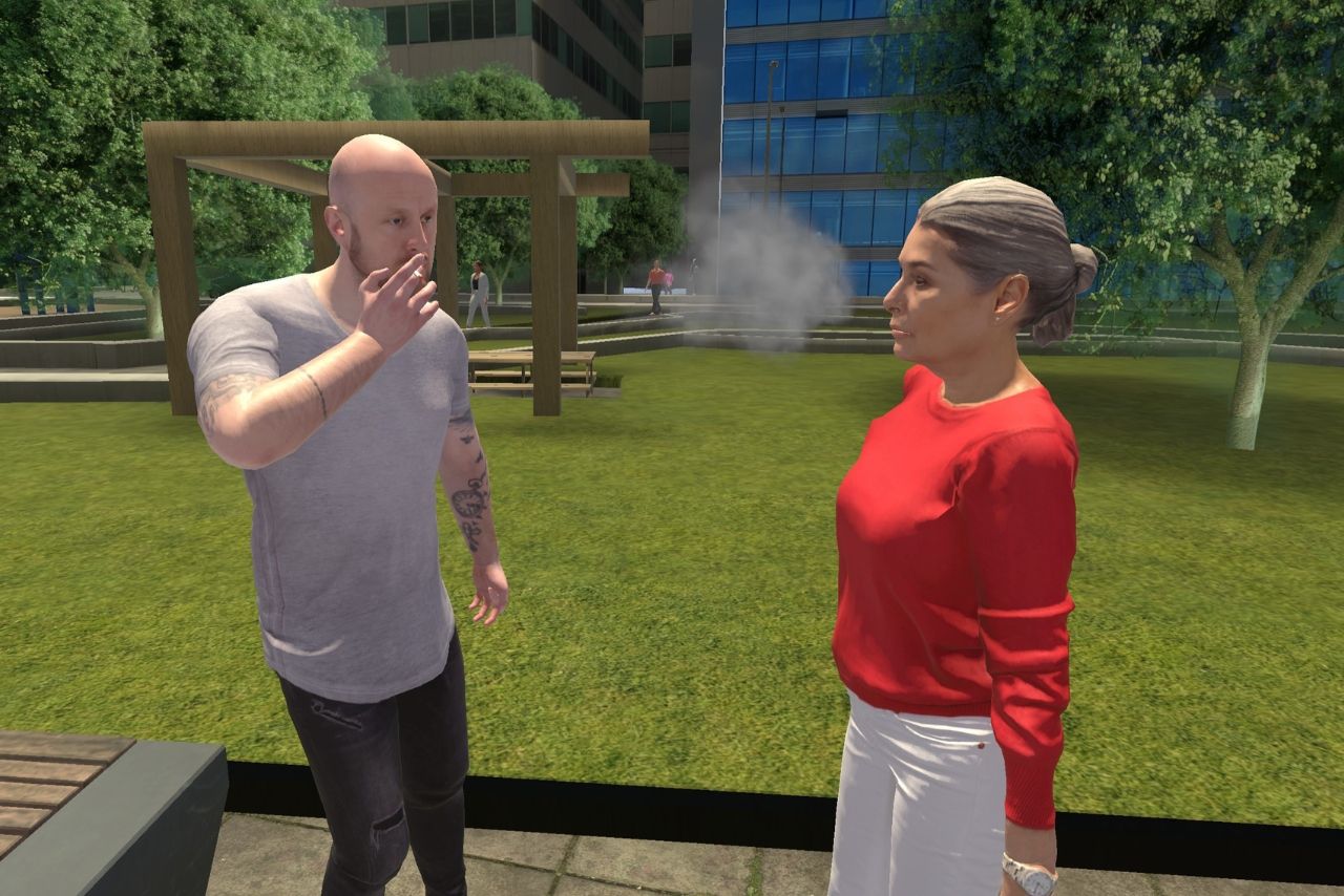 Une personne fume face à une autre dans un parc